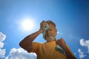 Photo of senior man suffering in heat