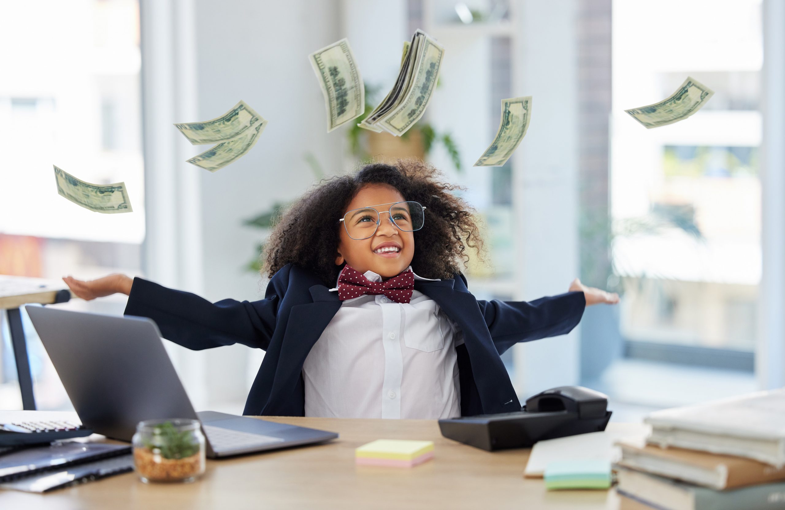child in a suit throwing money into the air
