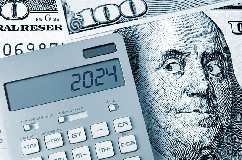 Benjamin Franklin looking at calculator on One Hundred Dollar Bill