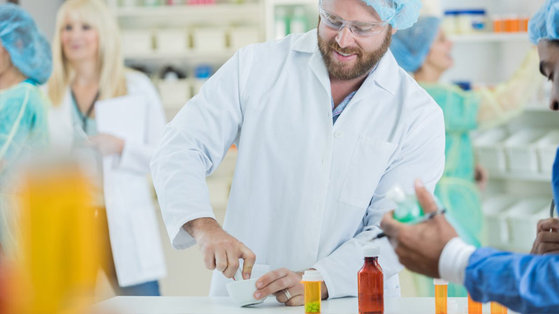 male pharmacist compounding medication male pharmacist compounding medication