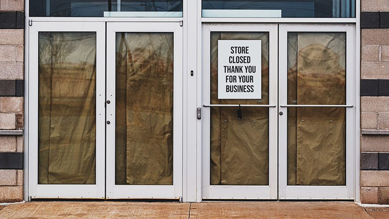 pharmacy with store closed sign posted on door