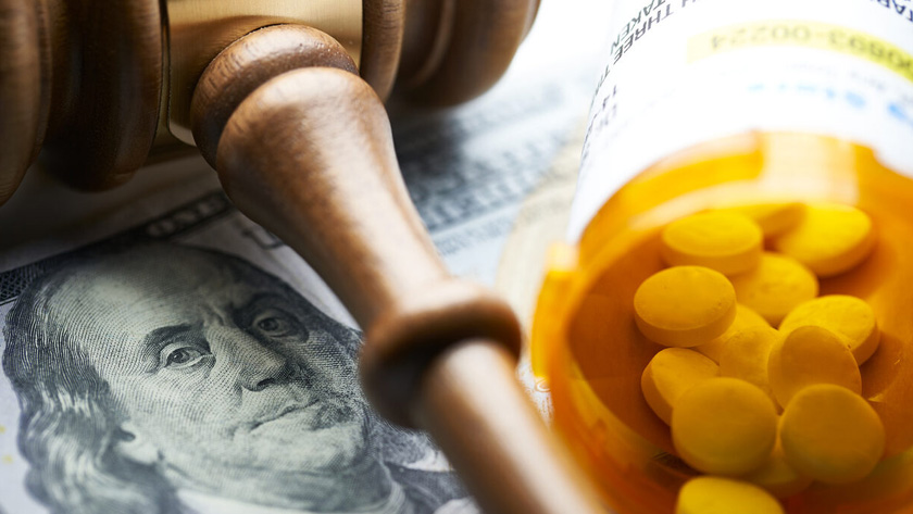 gavel and pill bottle on money