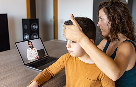 woman and child speaking to a doctor on a video call - Independent Pharmacy Cooperative