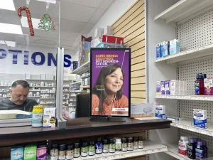 dolphin digital ooh screen displaying ad in pharmacy