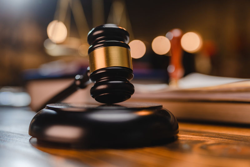 judge's gavel on bench in court room