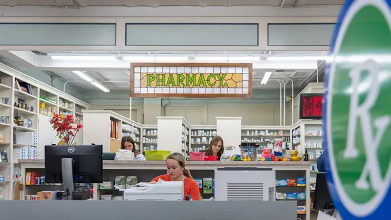 employees working behind pharmacy counter at The Drug Store in Jefferson WI