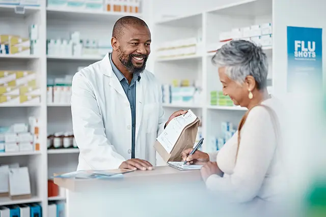 pharmacist and woman at counter with medicine or prescription drugs sales at drug store.