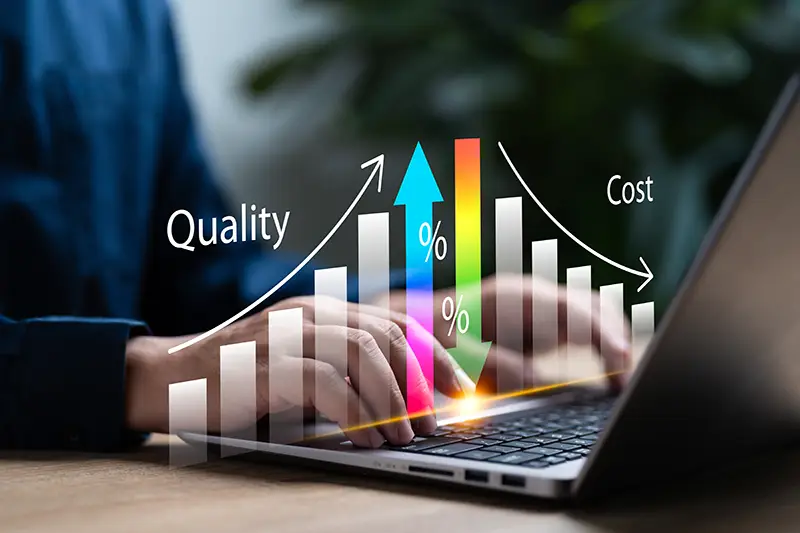 computer with a chart showing quality going up and cost going down