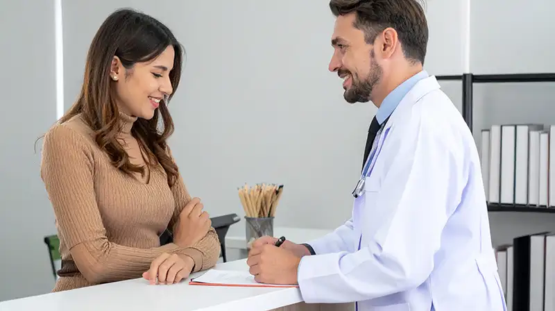 pharmacist speaking to doctor detailing patient care plan