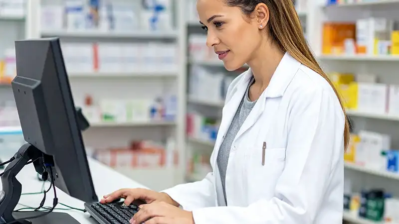 female pharmacist reviewing remote patient monitoring data