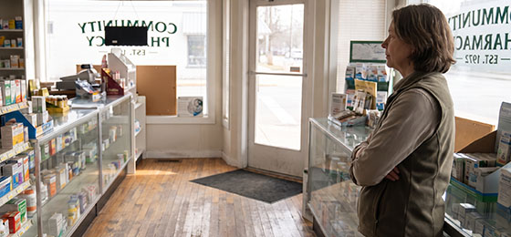 pharmacy owner standing in pharmacy